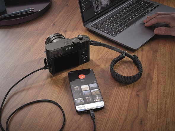 The full-frame unit is connected to an iPhone, Photos are accessed vis the Leica Fotos app